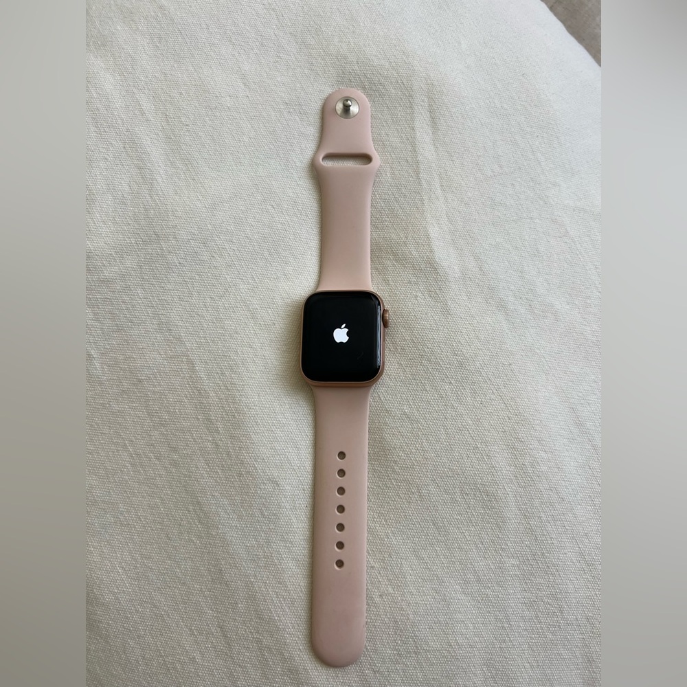 Apple Watch Series 5, 40 mm, gold aluminum case, pink sand sport strap.